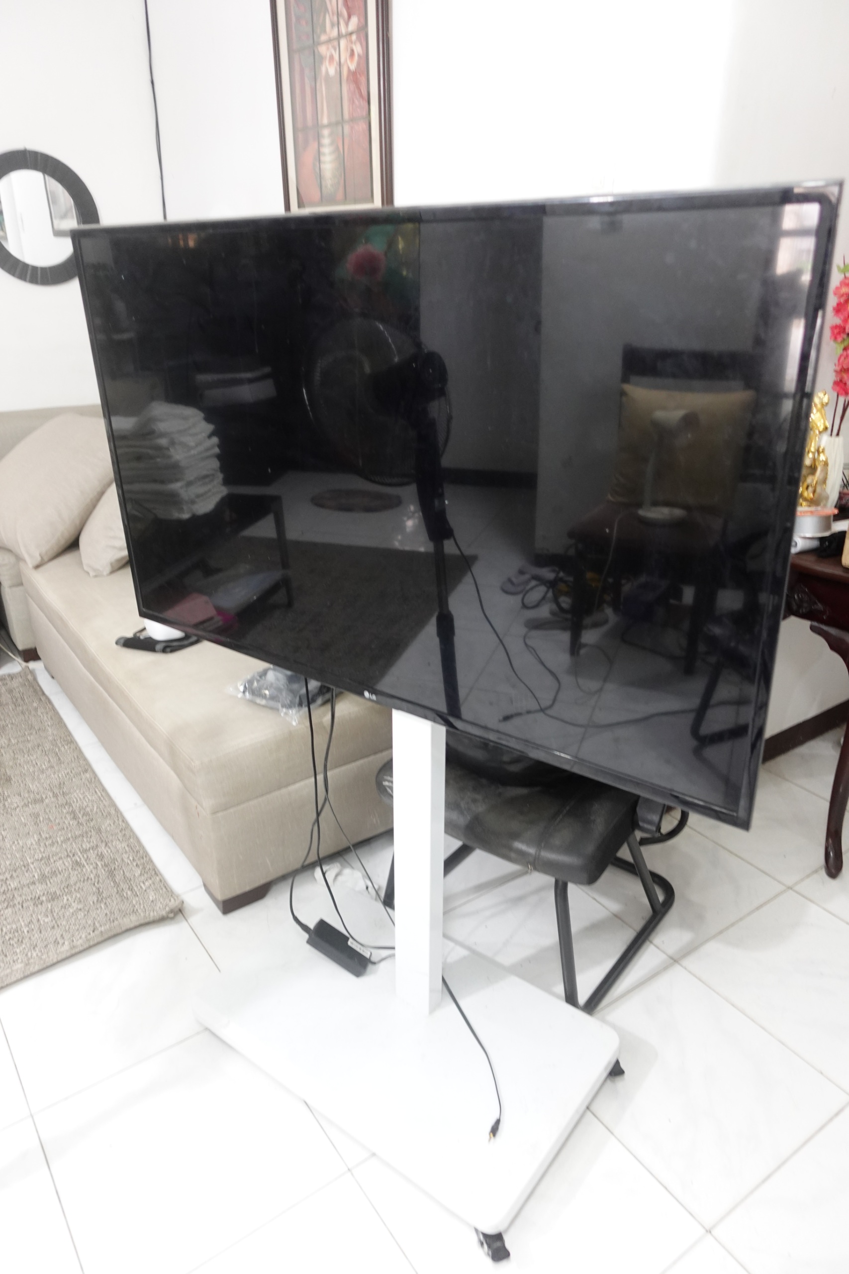 LG flat screen TV with wheeled stand