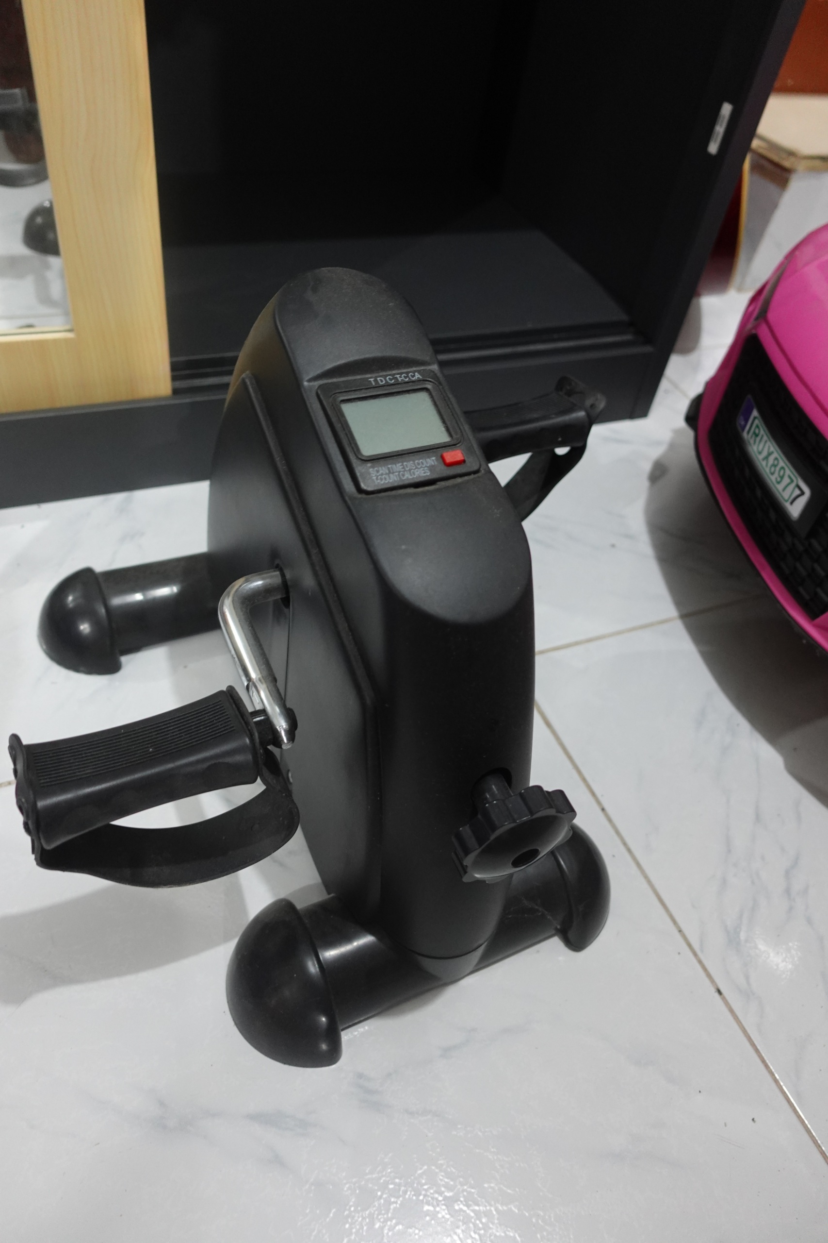 Compact under desk pedal exerciser with strap pedals and LCD